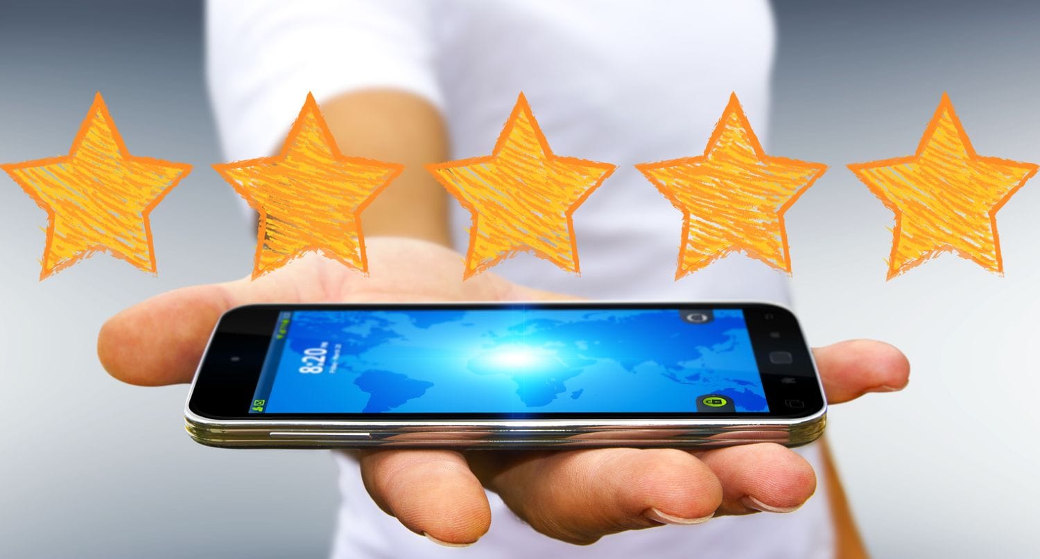 Mand holder mobiltelefon i hånden under 5 stjerner